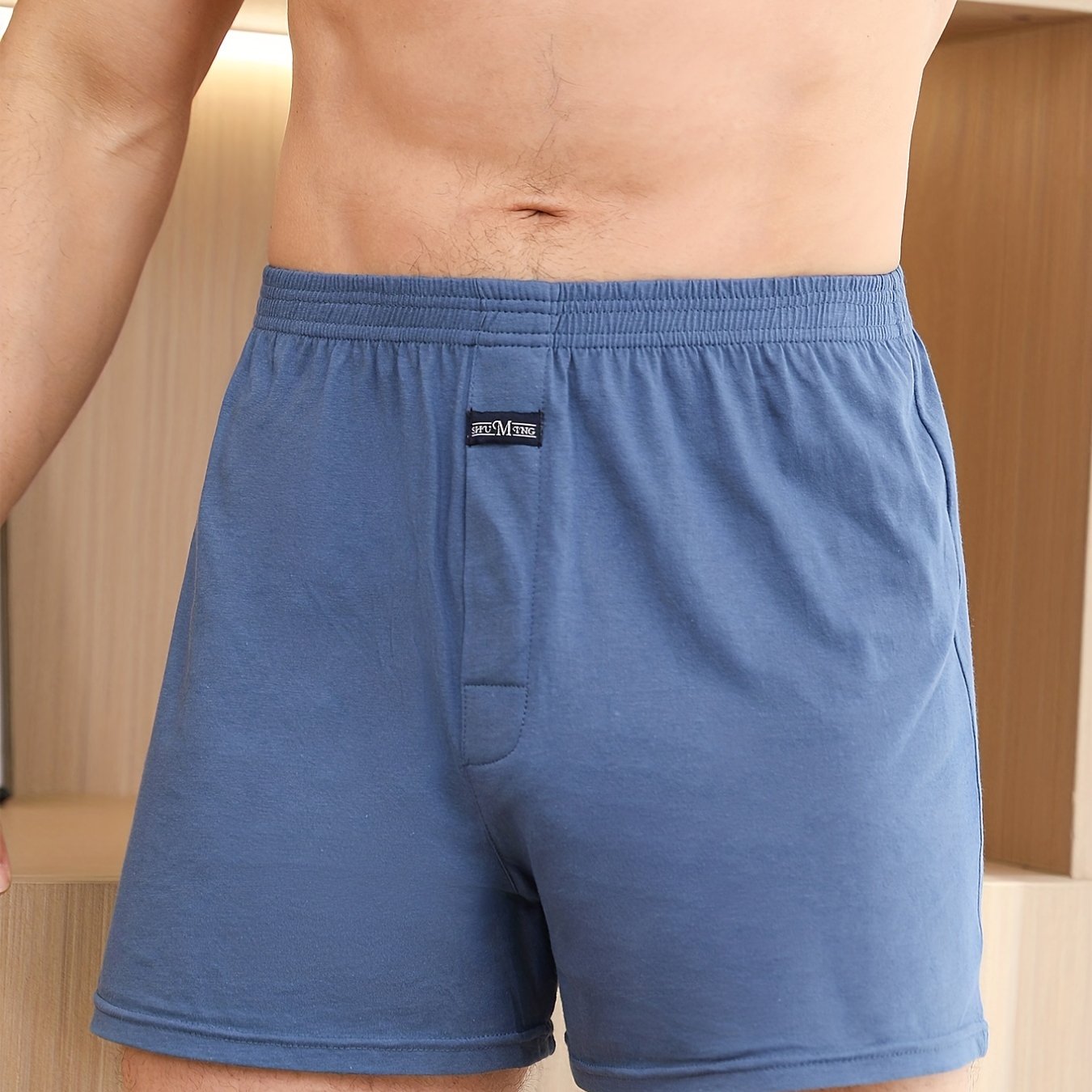 Calça de homem em algodão puro com estampado de flechas, larga, ideal para pijamas, de cintura subida e com gancho profundo.