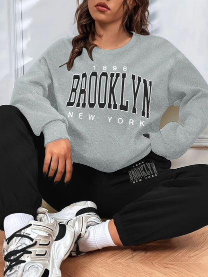Conjunto casual de duas peças com blocos de cor, composto por uma sweatshirt com estampado de letras e calças jogger desportivas. Roupas femininas.