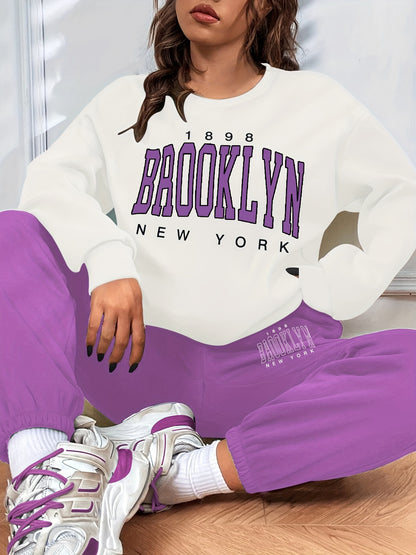Conjunto casual de duas peças com blocos de cor, composto por uma sweatshirt com estampado de letras e calças jogger desportivas. Roupas femininas.