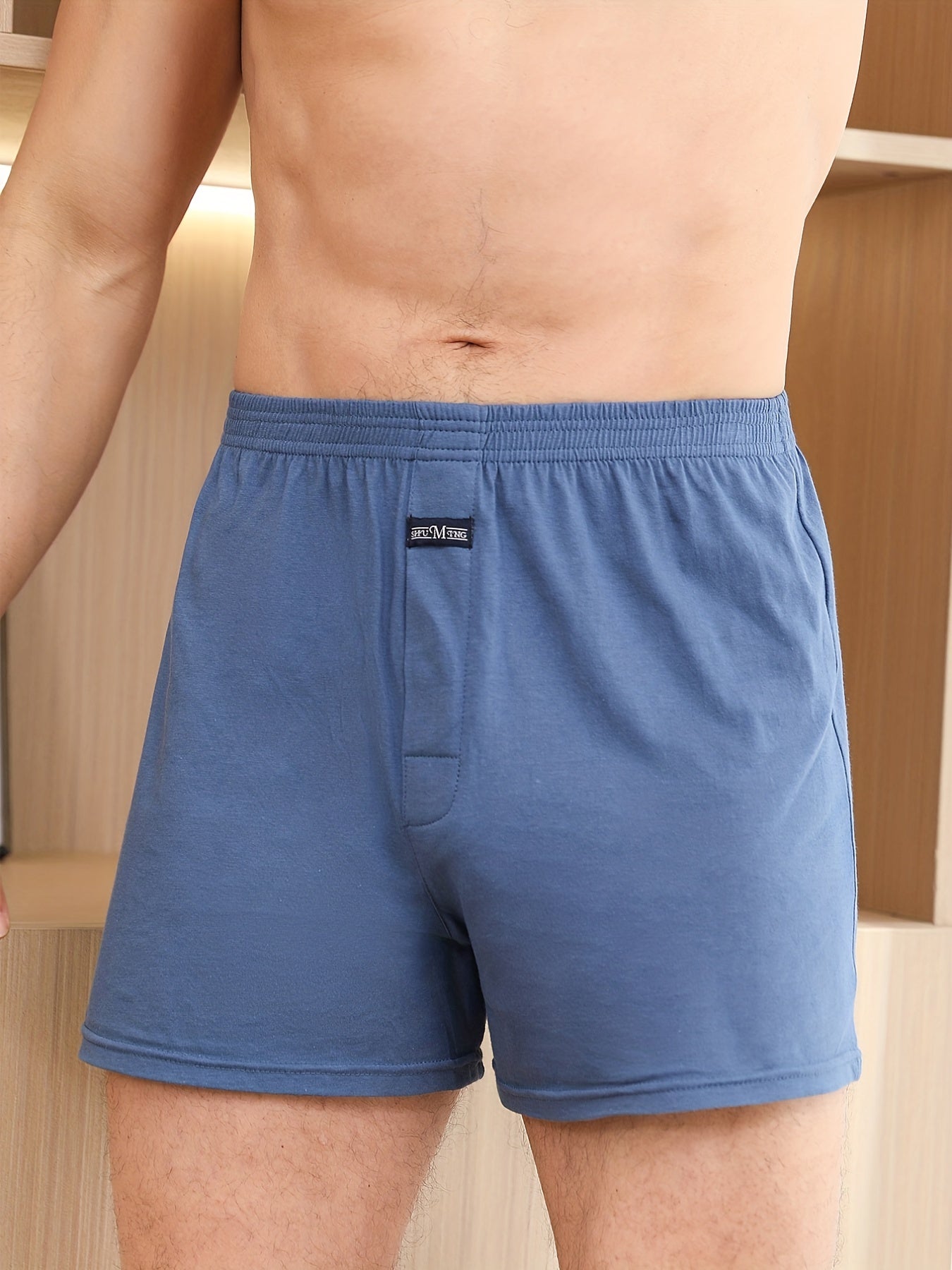 Calça de homem em algodão puro com estampado de flechas, larga, ideal para pijamas, de cintura subida e com gancho profundo.